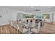 Open-concept living and dining area features a large dining table and a comfortable seating area with a TV at 7012 Oakwood St, Davenport, FL 33837