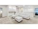 Large living room with a white sectional sofa, wet bar and neutral color palette at 7012 Oakwood St, Davenport, FL 33837