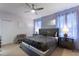 Well-lit main bedroom featuring a large bed, stylish curtains, and a ceiling fan at 7012 Oakwood St, Davenport, FL 33837