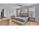 Comfortable main bedroom with a large bed, bedside tables, and natural light from two windows at 7012 Oakwood St, Davenport, FL 33837