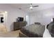 Well-lit main bedroom featuring a dresser, stylish curtains, and a ceiling fan at 7012 Oakwood St, Davenport, FL 33837
