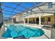 Relax in your private screened-in pool and spa with an outdoor seating area perfect for entertaining and enjoyment at 7012 Oakwood St, Davenport, FL 33837