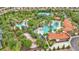 Aerial view of a community pool featuring a waterslide, and palm trees at 7012 Oakwood St, Davenport, FL 33837