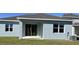 Backyard featuring a covered patio and sliding glass doors at 725 Ginger Dr, Haines City, FL 33844