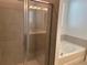 Modern bathroom showcasing a glass shower enclosure and separate soaking tub at 725 Ginger Dr, Haines City, FL 33844