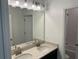 Elegant bathroom featuring double sinks, a granite countertop, and modern lighting fixtures at 725 Ginger Dr, Haines City, FL 33844