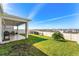 Backyard view featuring a covered patio area with plenty of space for outdoor furniture and activities at 7633 Agrigento St, Clermont, FL 34714
