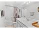 Bright bathroom featuring shower/tub combination and modern vanity with white countertop at 7633 Agrigento St, Clermont, FL 34714