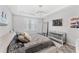 Comfortable bedroom with stylish lighting fixture, artwork, and mirrored dresser at 7633 Agrigento St, Clermont, FL 34714