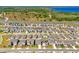 Aerial view of a meticulously planned community with neatly arranged modern homes near a greenbelt and lake at 7633 Agrigento St, Clermont, FL 34714