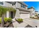 Well-maintained home featuring a two-car garage, lush landscaping, and a welcoming front entrance at 7633 Agrigento St, Clermont, FL 34714