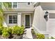 Inviting front door entrance with manicured landscaping, and a well-maintained exterior at 7633 Agrigento St, Clermont, FL 34714