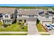 Charming two-story home with manicured lawn, garden beds, and a two-car garage at 7633 Agrigento St, Clermont, FL 34714
