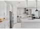Bright kitchen with white cabinetry, stainless appliances, and center island with pendant lighting at 7633 Agrigento St, Clermont, FL 34714