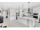 Modern kitchen featuring a large island, stainless steel appliances, and sleek white cabinetry at 7633 Agrigento St, Clermont, FL 34714
