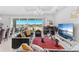 Bright living room with a large sliding glass door to the backyard and modern furnishings at 7633 Agrigento St, Clermont, FL 34714