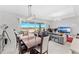 An open-concept living and dining room showcase seamless indoor-outdoor flow at 7633 Agrigento St, Clermont, FL 34714