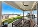 Inviting covered patio with ceiling fans, comfortable seating, and a grill, perfect for outdoor dining and relaxation at 7633 Agrigento St, Clermont, FL 34714