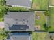 Aerial view of a home with a well-kept lawn, brick firepit, and solar panels at 861 Grazie Loop, Davenport, FL 33837