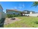 Well-maintained backyard with lush lawn, brick firepit, and cozy seating area at 861 Grazie Loop, Davenport, FL 33837