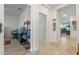 Hallway with tan tile flooring that leads to a bedroom and living area in the home at 861 Grazie Loop, Davenport, FL 33837