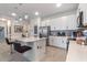Well-appointed kitchen featuring an island with seating, stainless steel appliances, ample white cabinetry, and modern pendant lights at 861 Grazie Loop, Davenport, FL 33837