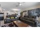 Spacious living room with leather couches, ceiling fan, and an open floor plan to the kitchen at 861 Grazie Loop, Davenport, FL 33837