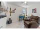 Cozy living room with tile flooring, chair, television, and other decor at 861 Grazie Loop, Davenport, FL 33837