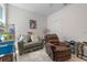 Cozy living room featuring a small couch, chair, and entertainment stand at 861 Grazie Loop, Davenport, FL 33837
