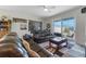 Comfortable living room with reclining leather sofas, a patterned rug, a ceiling fan, and sliding glass doors to the patio at 861 Grazie Loop, Davenport, FL 33837