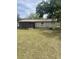 View of the back of the house, screened in back porch and green grass at 904 Hickory Ave, Fruitland Park, FL 34731