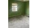 Empty bedroom with green walls, bare floors, and a window at 904 Hickory Ave, Fruitland Park, FL 34731