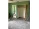 Empty bedroom with green walls, bare floors, and a closet at 904 Hickory Ave, Fruitland Park, FL 34731