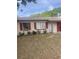 Charming single-story home with a red-trimmed roof, attached garage, and small front yard at 904 Hickory Ave, Fruitland Park, FL 34731
