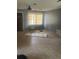Empty living room with gray walls, bare floors, and a window with blinds at 904 Hickory Ave, Fruitland Park, FL 34731