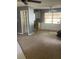 Empty living room with gray walls, bare floors, and a kitchen corner at 904 Hickory Ave, Fruitland Park, FL 34731