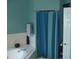 Bathroom with a garden tub, shower with blue curtains and tiled walls at 908 Hilly Bend Dr, Apopka, FL 32712