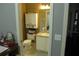 Cozy bathroom with a vanity, toilet, mirror, and storage cabinet at 908 Hilly Bend Dr, Apopka, FL 32712