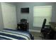 Bedroom with a cozy bed, a desk and chair next to a window, and a closet at 908 Hilly Bend Dr, Apopka, FL 32712