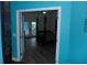 An open doorway offers a view of a bedroom with a four-poster bed, wood floors, and light streaming through a window at 908 Hilly Bend Dr, Apopka, FL 32712