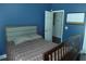 A bedroom featuring a bed, modern blue walls, and a convenient open doorway at 908 Hilly Bend Dr, Apopka, FL 32712