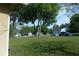 Well-manicured front yard with lush lawn and mature trees on a quiet street at 908 Hilly Bend Dr, Apopka, FL 32712
