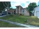 Charming home featuring a landscaped front yard, a two-car garage and a cozy, covered front porch at 908 Hilly Bend Dr, Apopka, FL 32712