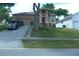 Charming home featuring a manicured lawn, inviting red front door, and lovely landscaping at 908 Hilly Bend Dr, Apopka, FL 32712
