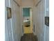 Hallway leading to a bathroom with a soaking tub, tile floors, and white trim at 908 Hilly Bend Dr, Apopka, FL 32712