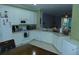 Functional kitchen featuring white cabinetry, tile flooring, and a complete set of appliances at 908 Hilly Bend Dr, Apopka, FL 32712