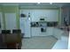 Spacious kitchen featuring white cabinets, modern appliances, and a tiled floor at 908 Hilly Bend Dr, Apopka, FL 32712