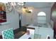 The living room has an elegant chandelier and a bright window with ample natural light at 908 Hilly Bend Dr, Apopka, FL 32712