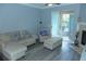 Bright living area with sliding glass doors, neutral tones, and comfortable seating arrangement at 908 Hilly Bend Dr, Apopka, FL 32712