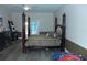Main bedroom showcasing a four-poster bed, wood floors, and a relaxing ambiance at 908 Hilly Bend Dr, Apopka, FL 32712